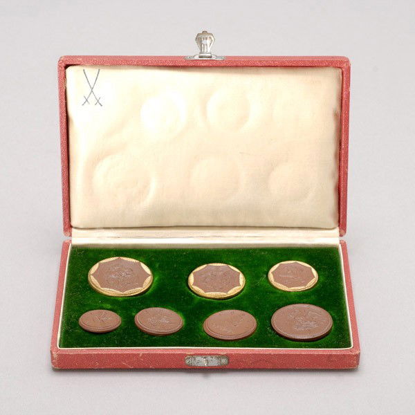 7 Meissen German Porcelain Coins in original box.: Set of seven Meissen German Porcelain Coins in original box. Provenance: From the Richard Smith Collection