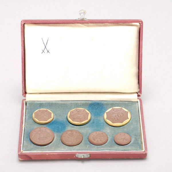 7 Meissen German Porcelain Coins in original box.: Set of seven Meissen German Porcelain Coins in original box. Provenance: From the Richard Smith Collection