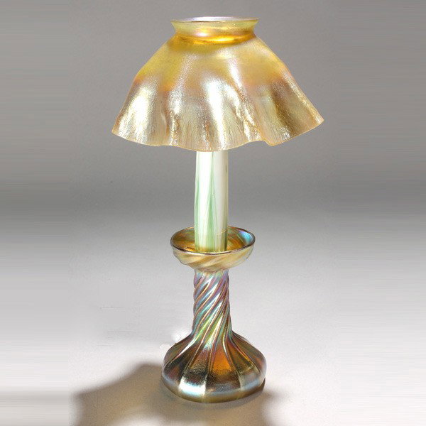 Tiffany Studios Gold Favrile Candlelamp: Tiffany Studios Gold Favrile Candlelamp gold twisted candlestick base with gold favrile shade, white glass insert with green pulled feathering, electrified Signed L.C.T. Favrile {Height 12 1/2 inches;