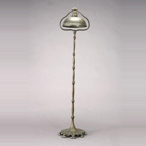 Tiffany Studios Bronze Floor Lamp, 1899-1918: Tiffany Studios Bronze Floor Lamp, 1899-1928 The cylindrical standard cast with a repeating lotus flower, the spreading base with scalloped edges ending in repeating twin spiral form horns, the invert
