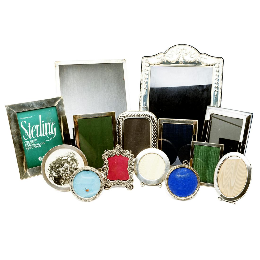 Collection of Sterling Silver Picture Frames: Collection of Sterling Silver Picture Frames. 21 frames total, various makers and sizes. {Approximate dimensions: 3 3/4 - 14 1/4 high x 3 - 10 5/8 inches wide.}. Condition: Some tarnish and wear throu