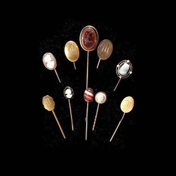 10 STONE, CAMEO, AGATE, C/P, Y/G, METAL STICKPINS.: COLLECTION OF TEN HARDSTONE, SHELL CAMEO, AGATE, CULTURED PEARL, YELLOW GOLD, METAL STICKPINS. Including one shell cameo, 10k yellow gold stickpin, one 10k yellow gold initial stickpin, one carved har