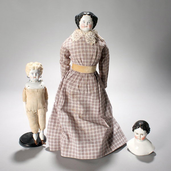 Two Jenny Lind China Head Dolls & a bust: Two Jenny Lind China Head Dolls; together with a similar bust {Height of taller doll 21 inches} [Leg repaired on tallest]