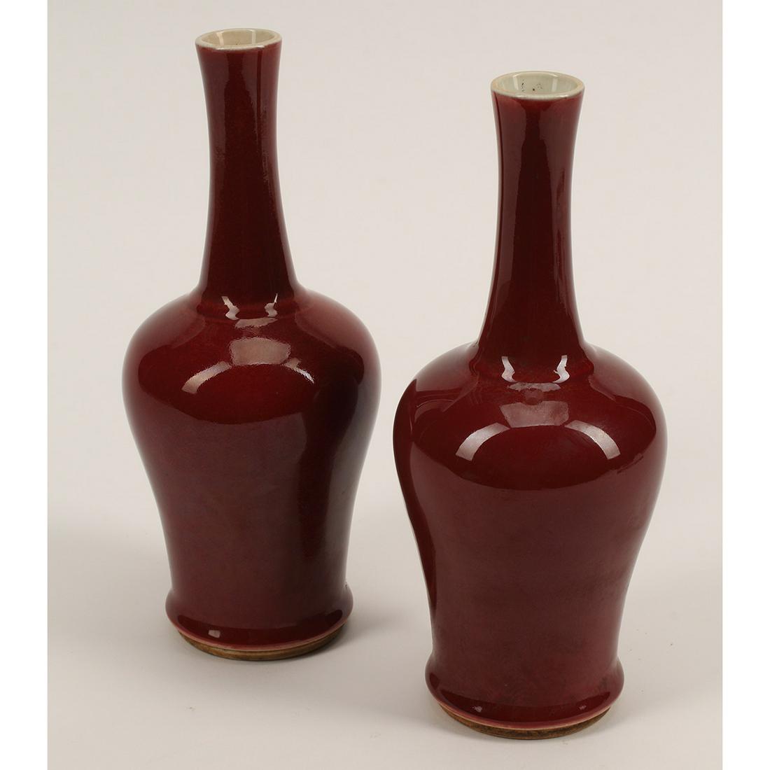 Pair of Chinese Porcelain Oxblood Vases: Pair of Chinese Porcelain Oxblood Vases. Of baluster body with a tall, slightly tapered neck, covered overall with oxblood red color, the interior and bottom remain ivory white, incised a double circl