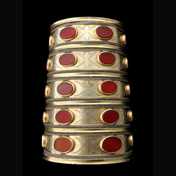 CARNELIAN, GLASS, SILVER GILT TRIBAL CUFF.