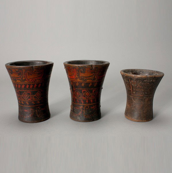 three inca kero vessels: Three KERO vessels. Two larger ones with painted bands of animals and geometric motifs; the other with incised designs of humans and floral motifs, traces of pigments. Height of one 6 3/4 inches. Each