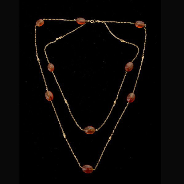 CARNELIAN, 14K YELLOW GOLD NECKLACE.: CARNELIAN, 14K YELLOW GOLD NECKLACE. Composed of nine oval circular beads measuring approximately 10 x 9 x 5 mm, interspaced by a 14k yellow gold link chain forming a 20 inch double strand or a 34 inc