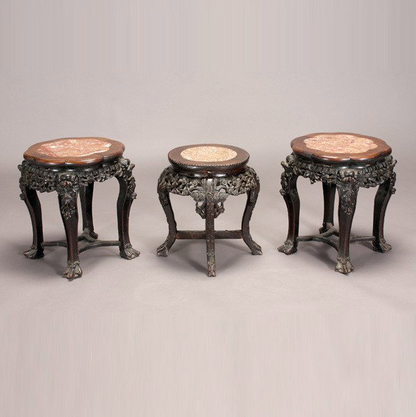 Three Chinese Export Hardwood Display Stands: Three Chinese Export Hardwood Display Stands, each inset with a marble panel above reticulated aprons of prunus branches and scrolling double gourds; one of circular form and two of flower form {Large