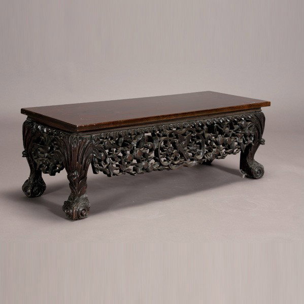 A Chinese Export Low Table: A Chinese Export Low Table, three sides ornately carved in openwork with leafy pomegranate branches surrounding reserves of birds, raised upon four hoof feet decorated with scrolls {Dimensions: 14 x 4