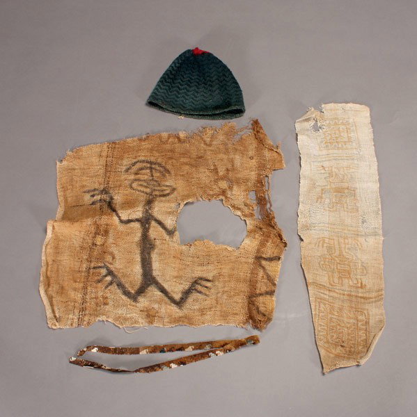 4 pre-columbian andes textiles: Four ancient ANDES textiles. Including a Cabuza (Chile) woven cap in indigo and red with four points at top four corners (300-700 A.D.); two painted gauze panels; and a thin band. Hat: 7 1/2 x 9 inche