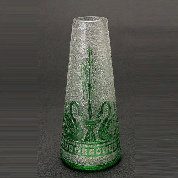 Baccarat Cameo Cut Vase: Baccarat Cameo Cut Vase The tapered cylindrical form with green overlay acid cut with a band of repeating pair of swans drinking from a fountain, over a band of square panels enclosing a button, the g