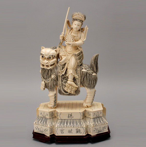 A Carved Ivory Figure Riding a Beast*