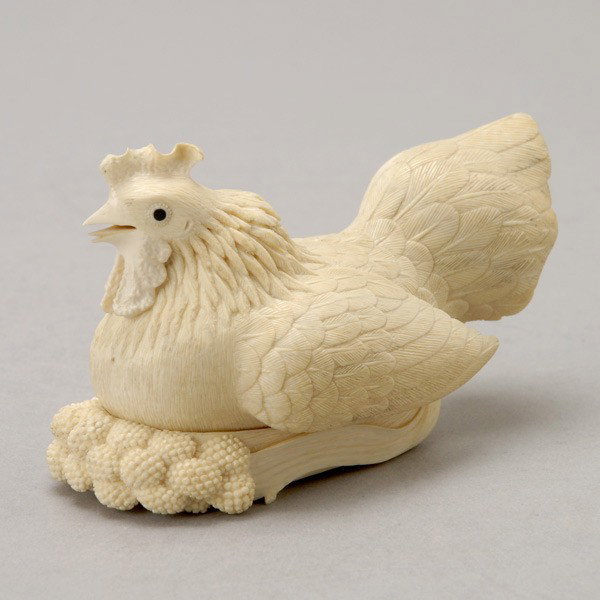 An Ivory 'Rooster' Box and Cover*: An Ivory 'Rooster' Box and Cover*, The bird seated with its feet coiled beneath its body, the feathers naturalistically defined, the underside of the box carved in relief with a flowering millet stem