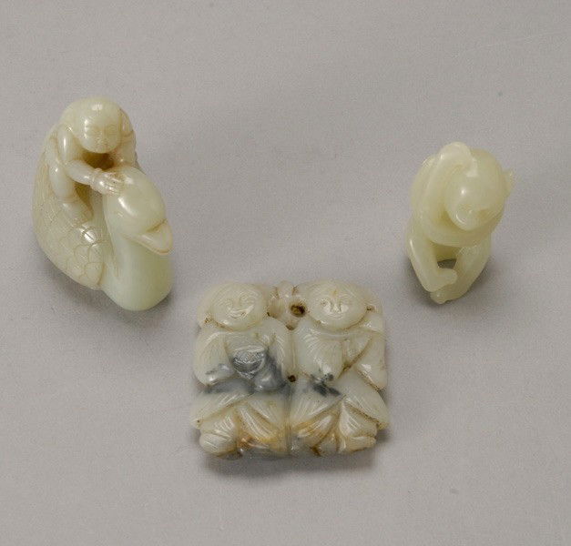 Three Jade Carvings: Three Jade Carvings, The first of the HeHe twins; the second of a boy riding duck; the third of a monkey scratching its head and with legs crossed, each stone of pale celadon color. Tallest: 2 5/8 inc