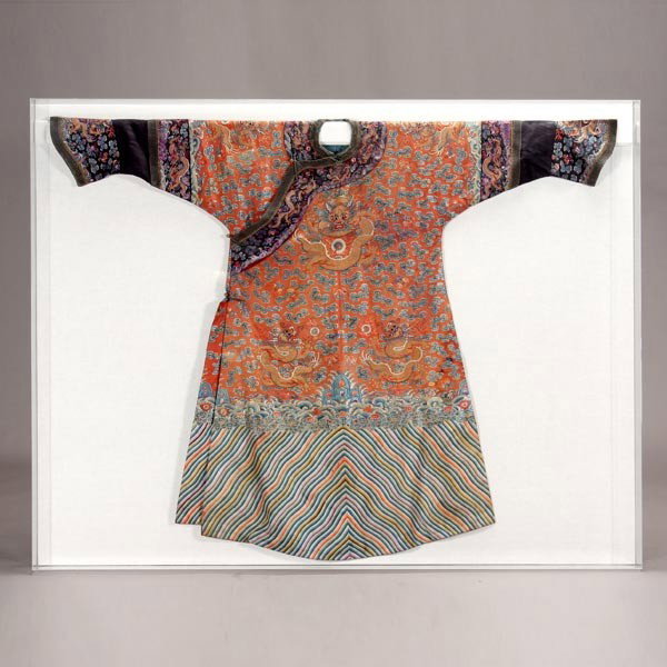 An Embroidered Red Ground Dragon Robe, Early 19th: An Embroidered Red Ground Dragon Robe, Decorated with five-clawed dragons of gilt threads chasing flaming pearls, shown entwined within a network of clouds, bats and peach sprigs, all above crashing w