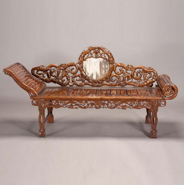 A Carved Hardwood Day Bed: A Carved Hardwood Day Bed, Carved with meandering bamboo stalks and grape vines, the back inset with a circular marble plaque. 30 1/2 x 74 x 22 3/4 inches (77.5 x 188 x 57.8 cm)