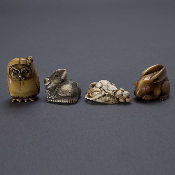 Four Ivory Animal-Form Netsuke*, Meiji Period: Four Ivory Animal-Form Netsuke*, Meiji Period, the first a standing owl with a worm resting upon its head, signed on the foot; the second a rabbit with large back-turned ears and inlaid orange eyes; t