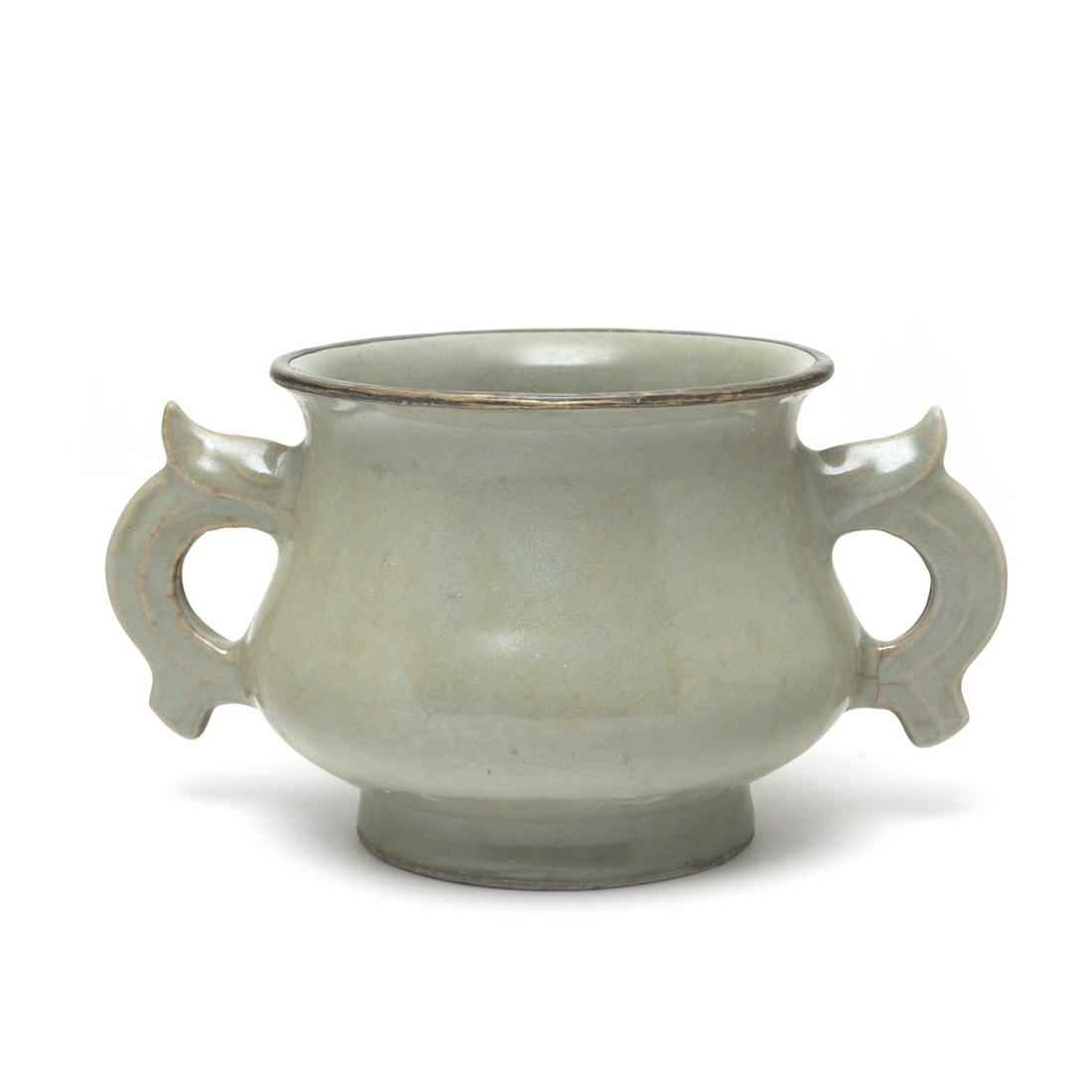 Chinese Longquan Celadon Censer: Chinese Longquan Celadon Censer. Of compressed globular body applied with a pair of archaistic dragon handles beneath a flared rim, covered with a sea green glaze, the rim bound in a metal band, the b
