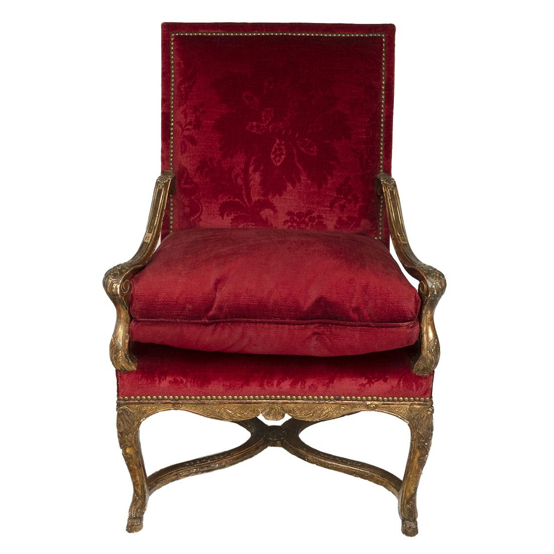 Louis XIV Giltwood Fauteuil: Louis XIV Giltwood Fauteuil. Carved giltwood frame, red voided velvet upholstery. {Approximate dimensions: 41 high x 27 wide x 30 inches deep.}. Condition: Significant surface wear and patina througho