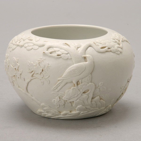 A White Glazed Porcelain Jar: A White Glazed Porcelain Jar, with an applied decoration of a bird standing upon garden rocks, a mark to the base {Height: 3 1/2 inches (8.9 cm)}