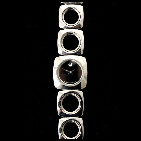 MOVADO MYSTERY STAINLESS STEEL WATCH.: MOVADO MYSTERY STAINLESS STEEL WATCH. DIAL: Round, black steel dot at 12 o'clock, dauphine hands, Movado. MOVEMENT: Quartz (not opened). CASE: Stainless steel, square snapback, 84A1 1310, 7385442. BRA