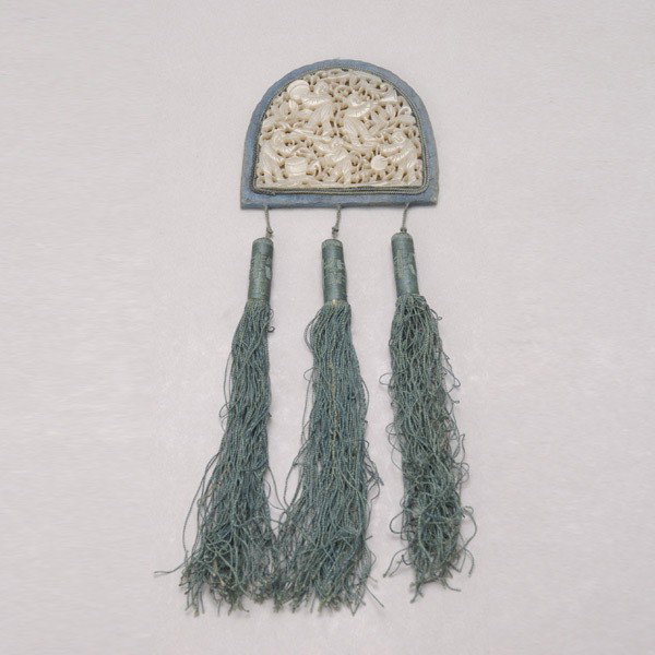 A Reticulated Jade Pendant and Mirror: A Reticulated Jade Pendant and Mirror, depicting five boys in play, a glass mirror to the reverse, with silk tassels {Width of Pendant: 2 1/2 inches (6.4 cm)} [Soiling]