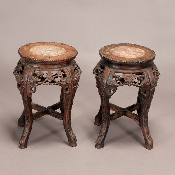 A Pair of Carved Hardwood Circular Display Stands: A Pair of Carved Hardwood Circular Display Stands, with marble insets {Height: 17 1/2 inches (44.5 cm)} [Wear, soiling]