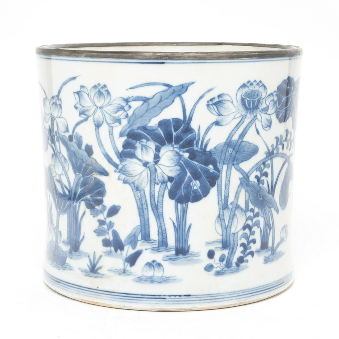 Chinese Blue and White Brushpot: Chinese Blue and White Brushpot. Of slightly waisted cylindrical body, painted in rich blue tones of aquatic birds amid blossoming lotus plants, the rim bound in a metal band, the base with an inscrip