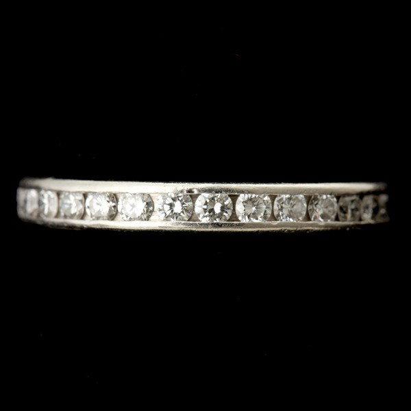 DIAMOND, PLATINUM ETERNITY RING, TIFFANY & CO.: DIAMOND, PLATINUM ETERNITY RING, TIFFANY & CO. Featuring thirty full-cut diamonds weighing a total of approximately 1.50 ct., channel set in platinum. Signed Tiffany & Co. Size 9 1/4, 3.10 dwts