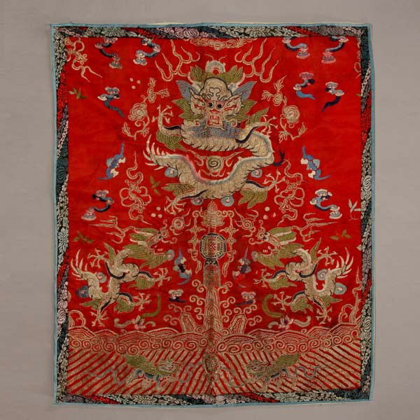 An Embroidered 'Dragon' Panel, Qing Dynasty: An Embroidered 'Dragon' Panel, Qing Dynasty, depicting three five-clawed dragons chasing flaming pearls, embroidered in golden threads to a vibrant red ground {31 x 25 1/2 inches (78.7 x 64.7 cm)} [St
