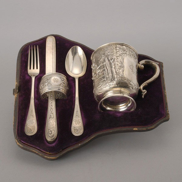 Victorian Sterling Cased Youth Presentation Set:: Victorian Sterling Cased Youth Presentation Set: comprising a cup with elaborate chased and repousse scene of children playing, bearing inscription "To Norman Clark Neill From his Uncle Norman", circa