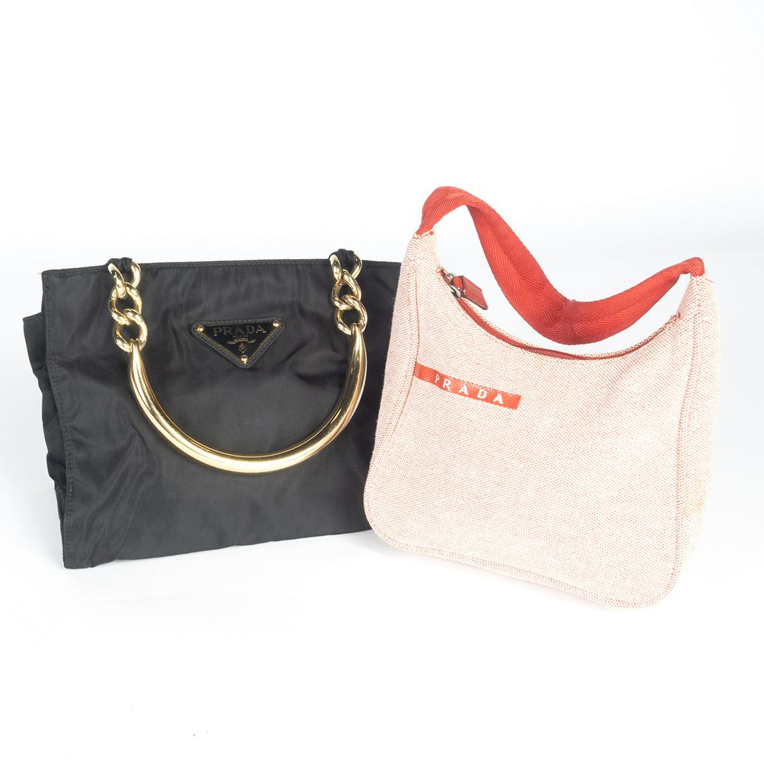 Two Prada Handbags: Two Prada Handbags. Red canvas with nylon strap handle, lined with red nylon monogram interior; lined with black nylon monogram interior with brass handle. Red leather PRADA strip label to exterior, r