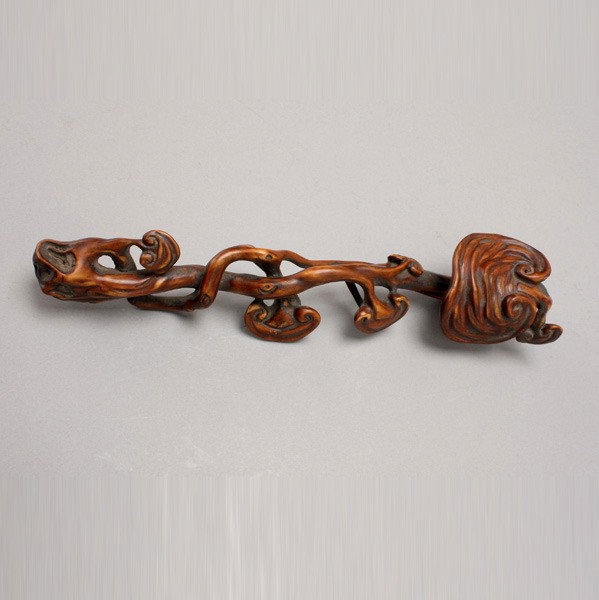 A Carved Boxwood Ruyi Scepter: A Carved Boxwood Ruyi Scepter, carved as a gnarled stem of lingzhi fungus carved in relief and openwork along the stem on both sides with smaller projecting sprigs and hollowed gnarls leading up to th