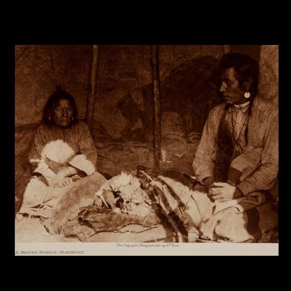 EDWARD CURTIS, Two works, photogravures: EDWARD CURTIS (American 1868-1952) Two works: "Half Shorn- Nez Perce, 1910" and "A Beaver Bundle- Blackfoot, 1926" Both from the book "The North American Indian" Along with a page from "The Page" Both