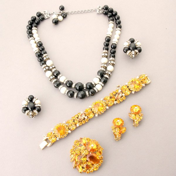 Assortment of Weiss and Hobe Jewelry: Assortment of Weiss and Hobe Jewelry, Including a Weiss amber pin and earrings with associated amber bracelet, and a Hobe double strand black, white, and rhinestone necklace and earrings.