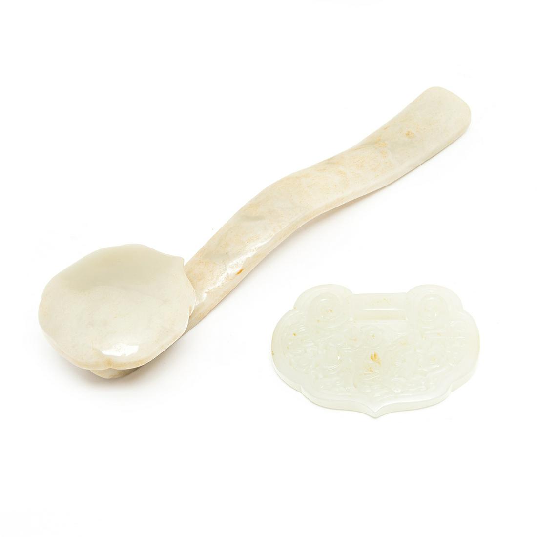 A Celadon Jade Ruyi and a Pendant: (Lot of Two) A Celadon Jade Ruyi and a Pendant. Comprising a carved jade Ruyi scepter and a pierced carved Ruyi shaped white jade pendant. {Largest: length 8 inches (20.3 cm)}.