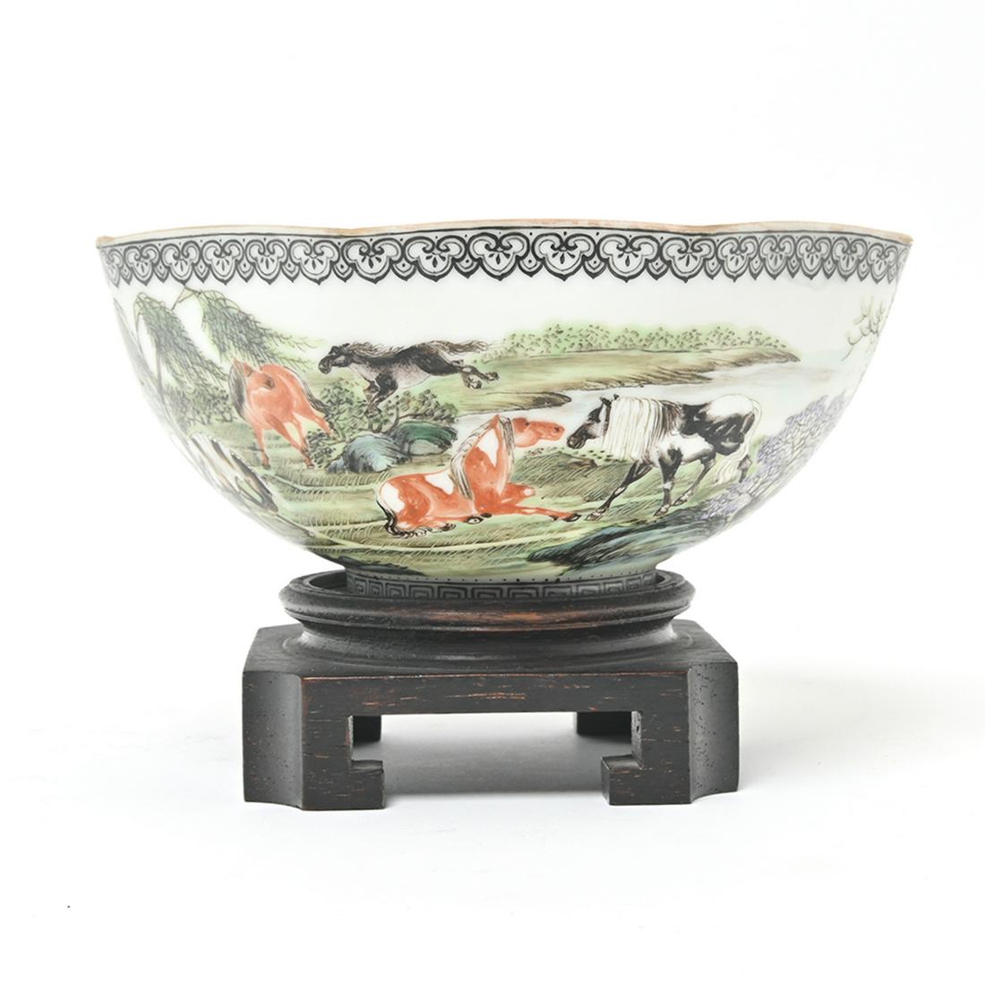 Chinese Eggshell Famille Rose Porcelain Bowl.: Chinese Eggshell Famille Rose Porcelain Bowl. Depicts horses in a hilly landscape, fitted on a wooden base. {Width 5 1/4 inches (13.3 cm)}.