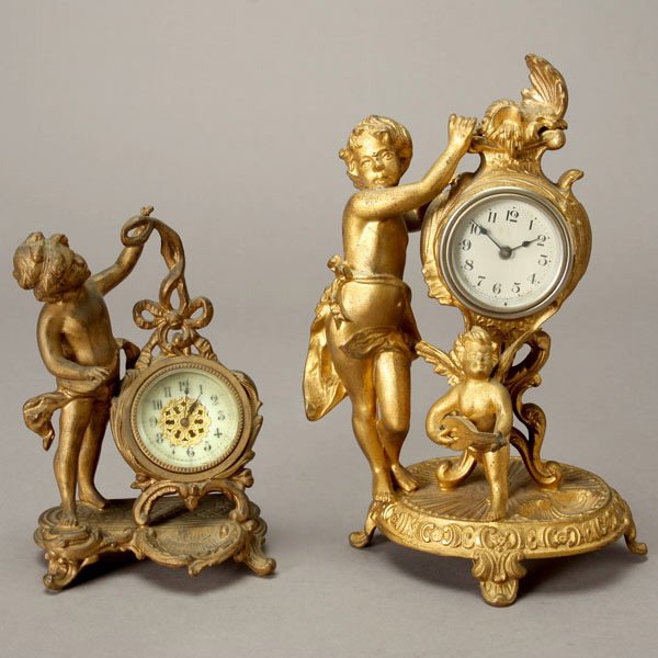 Two Gilt Metal Figural Clocks: Two Gilt Metal Figural Clocks, one clock "Made by the New Haven Clock Co." {Height of taller 9 1/2 inches}