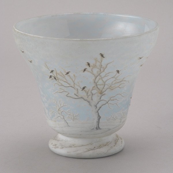 Daum Nancy Pictorial Vase: Daum Nancy Pictorial Vase. The ovoid form with a wide flaring rim, cut with a continuous snowy landscape featuring black birds perched on a dormant fruit tree against a pale blue translucent ground, t
