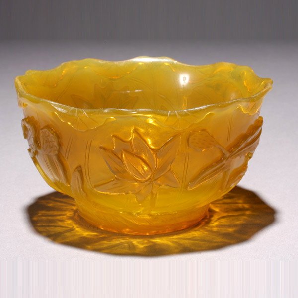 A Chicken-Fat-Yellow Glass Lotus Leaf Bowl: A Transparent Chicken-Fat-Yellow Glass Lotus Leaf Bowl, Modeled as a large lotus leaf with the folded edge forming a scalloped rim, the exterior with incised lines indicating the veins, carved in reli