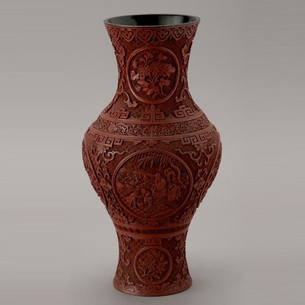 A Cinnabar Lacquer Baluster Vase, Late Qing: A Cinnabar Lacquer Baluster Vase, Carved with figures in tree-strewn landscapes within bands of lotus flowers on a diaper pattern ground, the neck carved with peony and lotus blossoms enclosed within