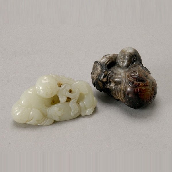 Two Jade Figural Carvings: Two Jade Figural Carvings, the first of Liuhai with his three-legged money toad resting on a lotus leaf, the stone of black and grayish tone; the second of boy next to a deer grasping a lingzhi fungus
