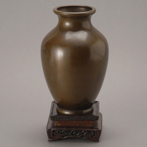 A Japanese Patinated Bronze Vase: A Japanese Patinated Bronze Vase, with high shoulders and flaring neck, the recessed base with a two-character mark {Height: 10 inches (25.4 cm)} [Overall wear]