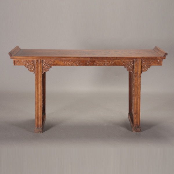 A Rectangular Huali Altar Table: A Rectangular Huali Altar Table, decorated with an apron carved in relief with dragons in opposition while chasing a flaming pearl, the legs fitted with reticulated panels depicting further dragon scr