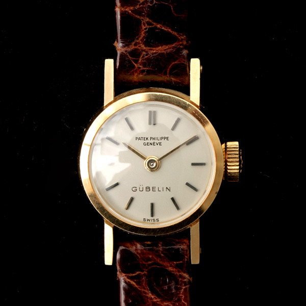 LADIES PATEK PHILIPPE GUBELIN 18K Y/G WRISTWATCH.: LADIES PATEK PHILIPPE GUBELIN 18K YELLOW GOLD WRISTWATCH. DIAL: Round, textured off white, applied gold baton hour markers, baton hands Patek Philippe Geneve, Gubelin. MOVEMENT: Twenty jewels, adjuste