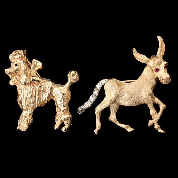TWO RUBY, DIAMOND, DONKEY 14K YELLOW GOLD BROOCHE: COLLECTION OF TWO RUBY, DIAMOND, DONKEY 14K YELLOW GOLD BROOCHES. Including one ruby, diamond, 14k yellow gold donkey brooch together with one 14k yellow gold poodle brooch. 9.3 dwts
