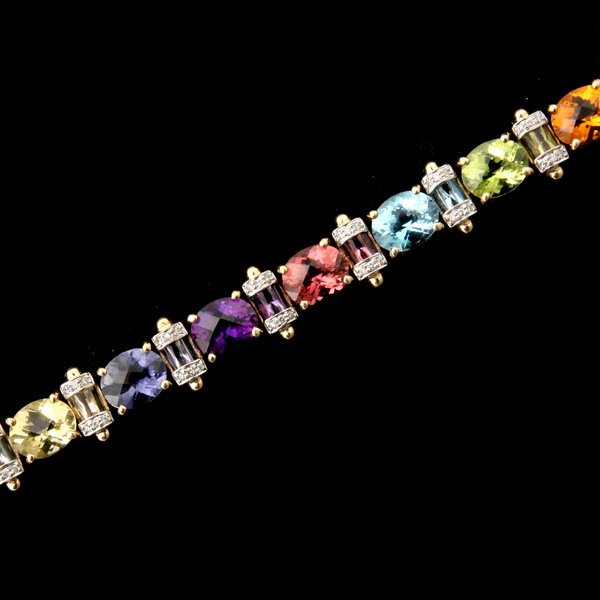 MULTI-STONE, DIAMOND, 18K YELLOW GOLD BRACELET.: MULTI-STONE, DIAMOND, 18K YELLOW GOLD BRACELET. Each link features fourteen oval faceted stones, accented by three rectangular matching stones. The stones include topaz, iolite, amethyst, peridot, tou