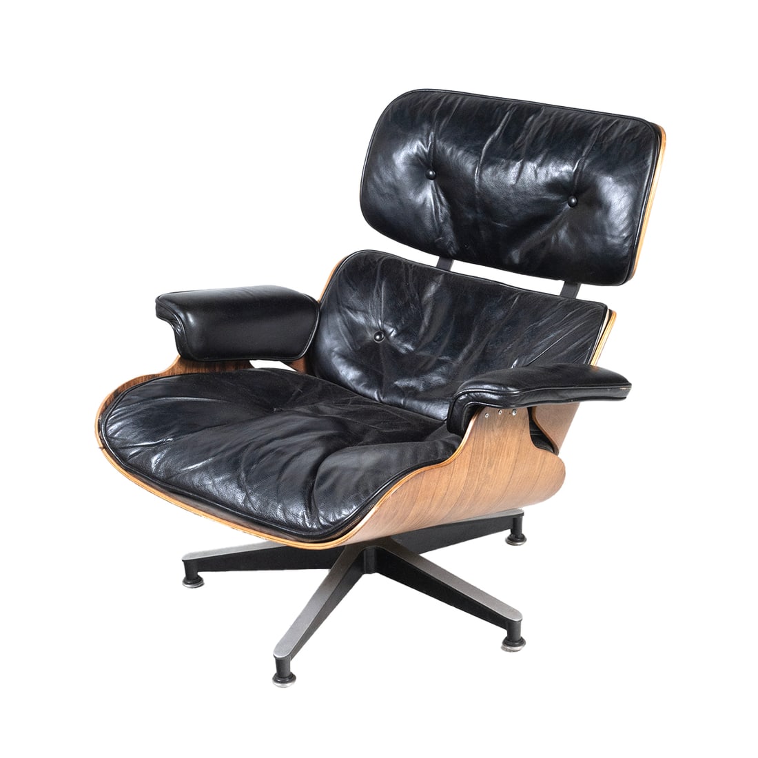 Eames For Herman Miller 670 Lounge Chair: Eames For Herman Miller 670 Lounge Chair. Rosewood veneer, black leather upholstery. Herman Miller label and badge to underside. {Approximate dimensions: 31 high x 33 1/4 wide x 35 inches deep.}. Cond