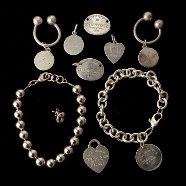 COLLECTION OF STERLING SILVER ITEMS.: COLLECTION OF STERLING SILVER ITEMS. Including one sterling silver bead bracelet; one Tiffany & Co. sterling silver bracelet; two Tiffany & Co. key rings; three sterling silver pendants; two sterling 
