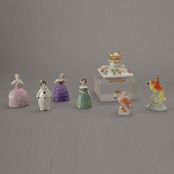 Seven Porcelain Perfume Bottles: Seven Porcelain Perfume Bottles: an old Paris squared squat form with handpainted fruit and floral sprays and a "jeweled" stopper (repaired); and six German bottles including three of female figural f